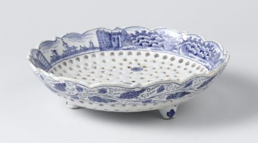 Fruit dish of blue-painted faience, with holes in a flower shape