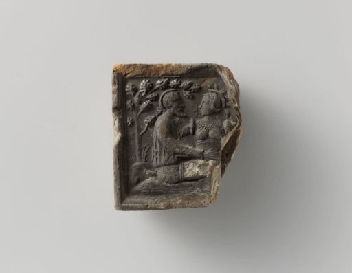 Fragment of a fireplace stone with a representation of a courting couple