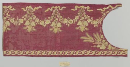 Fragment of red silk fabric with embroidery in yellow and light green