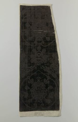 Fragment of black velvet with cut-outs featuring a pattern of pomegranate motifs