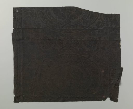 Fragment of black silk damask with a pattern of stylized pomegranate motifs
