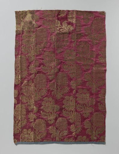 Fragment of wine-red satin with gold thread, pattern of large and small flowers on branches with leaves
