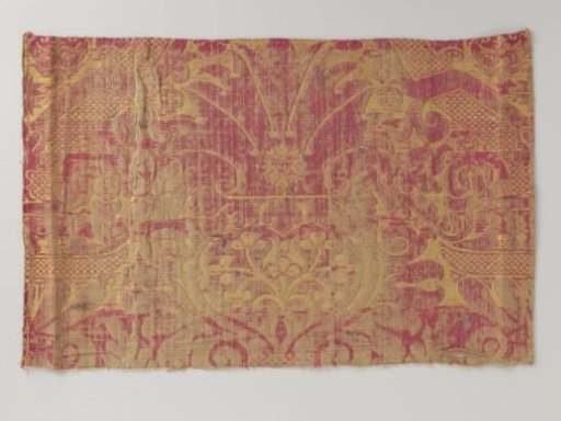 Fragment of yellow and red silk brocatelle with a pattern of floral ornaments flanked by vases