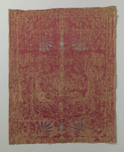Fragment of red and yellow brocatel with a pattern of a crowned wreath from which flowers rise