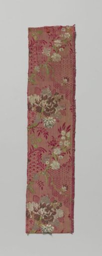 Fragment of red brocaded silk with a multicolored pattern of bouquet and floral garlands and so-called kantrand