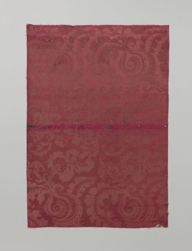 Fragment of red silk damask with a pattern of shell-shaped figures with curled foliage and floral work