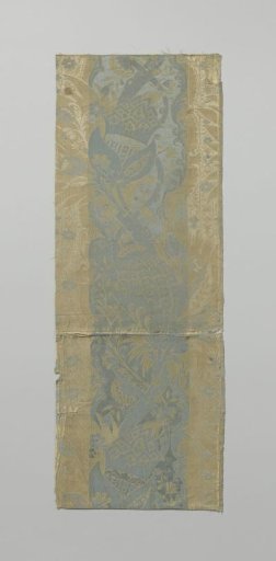 Fragment of white and blue striped silk lampas with a pattern of stems with leaves containing pomegranates and smaller flowering branches
