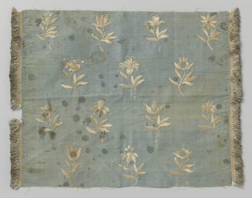 Fragment of silk fabric with embroidery