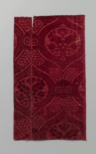 Fragment of dark red silk velvet with cutouts
