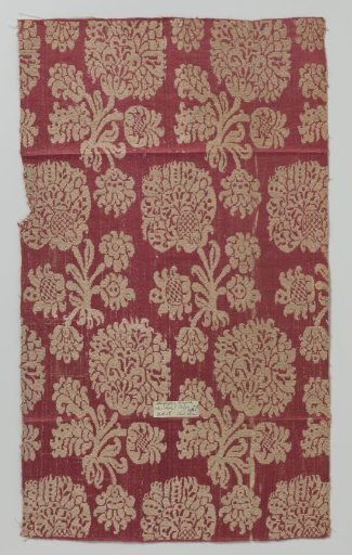 Fragment of red half-silk fabric with floral pattern