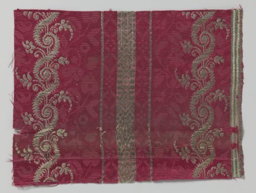 Fragment of red silk with floral pattern in silver thread
