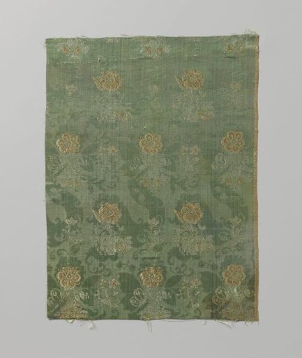 Fragment of silk satin with flowers on a green ground