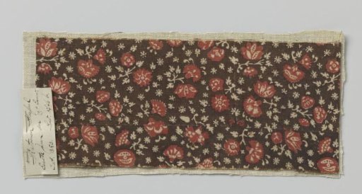 Fragment of linen, dark brown background, scattered with flowers