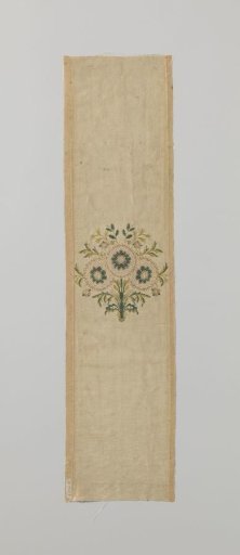 Fragment of brocaded silk with a flower in yellow and green