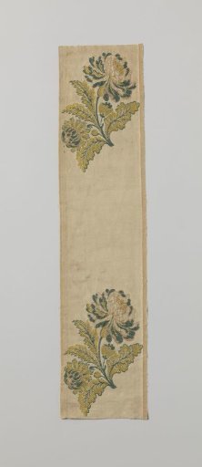 Fragment of brocaded silk with a flowering branch in yellow and green