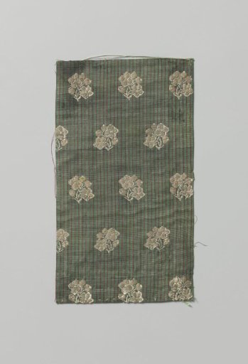 Fragment of striped silk fabric with flowers