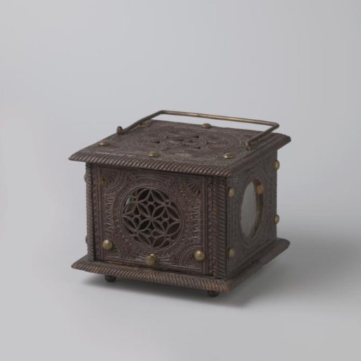 Stove with two glass medallions, one painted with three female figures seated at a meal
