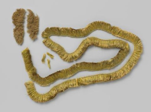 Fringe of green wool belonging to a pillowcase
