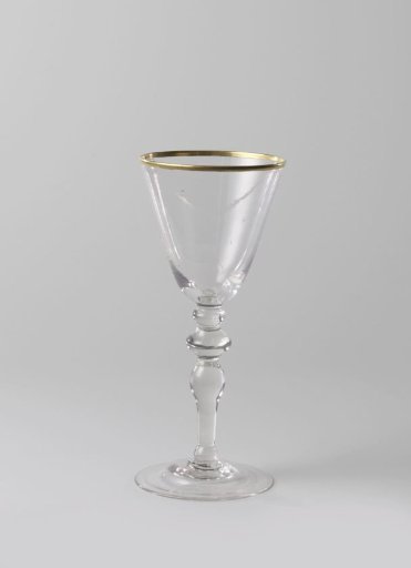 Chalice glass with a gilded rim along the mouth edge