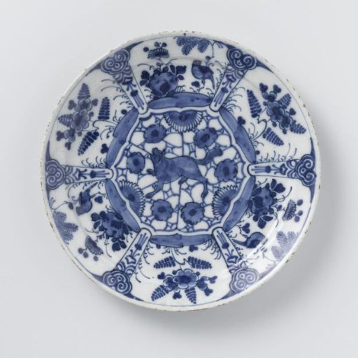 Plate of blue and white Delftware, decorated with plants and birds and a growling wolf or fox in the center