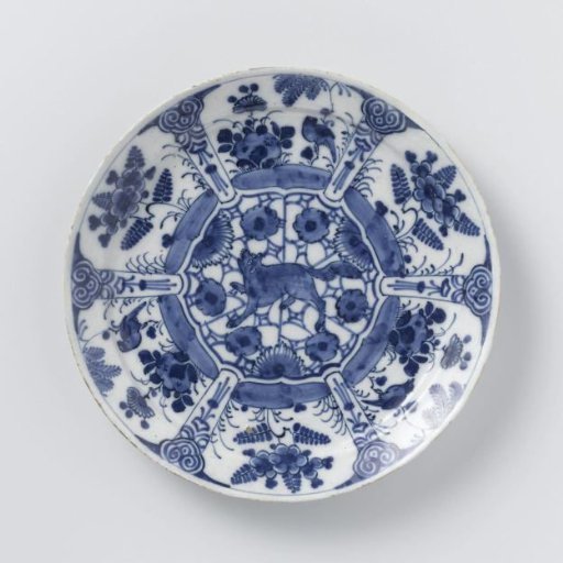 Plate of blue and white Delftware, decorated with plants and birds and a growling wolf or fox in the center