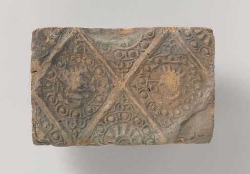 Fireplace with a depiction of a male and a female head, set in two panels