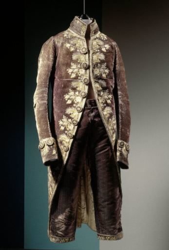 Jacket or skirt of faded dark blue velvet with pleats, embroidered in multicoloured silk with floral motifs and a binding of hearts