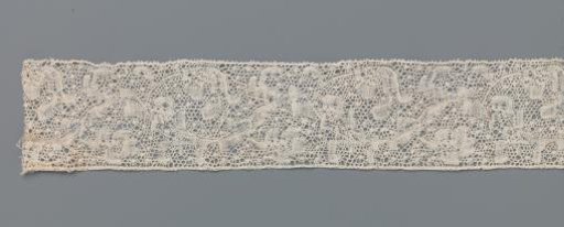 Strip of bobbin lace with lobed flower and iris-like flower on vine