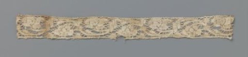 Strip of bobbin lace with upward and downward curling flower branch on continuous vine