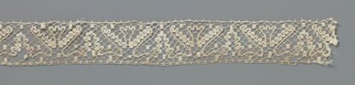 Strip of bobbin lace with triangular fields and stylized cup flower