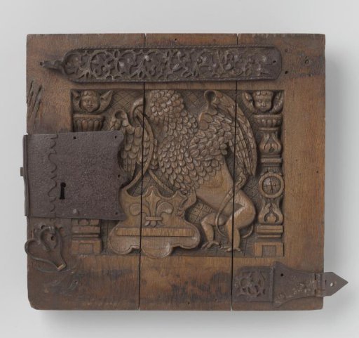 Door of a cabinet with a carved griffin and a coat of arms with a bar and lily