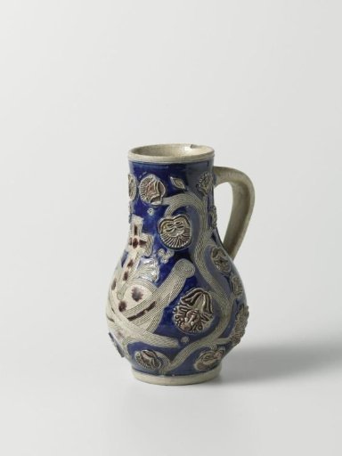 Jug with a cross above a heart among floral scrolls
