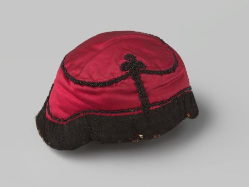 Cap of crimson satin, adorned with coral