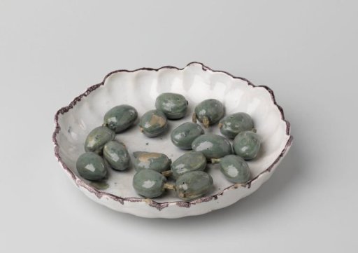 Plate with a scalloped rim and applied olives