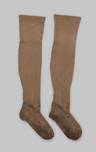 Stocking of plain brown silk with a band of white embroidery at the ankle and a narrow turned-down hem, finished in beige