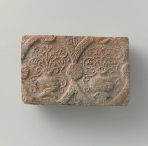 Fireplace with a depiction of two flower vases in medallions