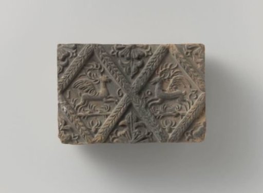 Fireplace with panes featuring winged stags