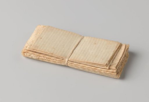 Stack of ten cloths, bound with a band