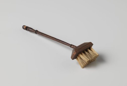 Whisk with profiled handle, with remnants of pink ribbon attached