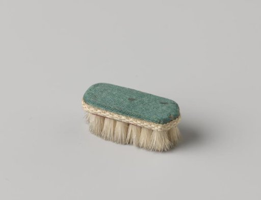 Saddle, covered in blue-green silk, trimmed with white ribbon