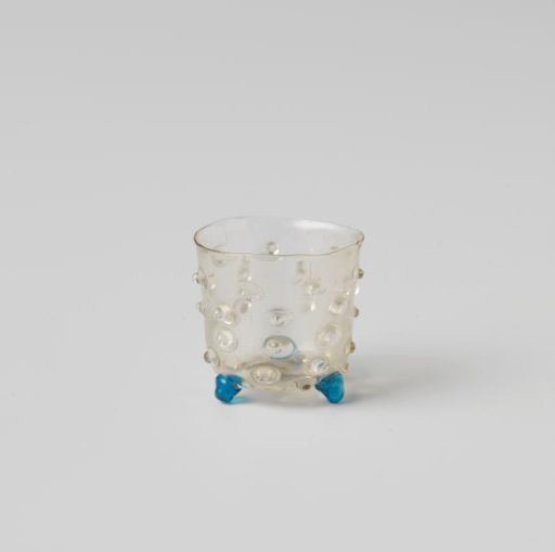 Cup decorated with bosses and knobs, on three spherical feet