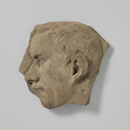 Fragment of a tile with a bas-relief in semi-fired clay, showing part of a man's head