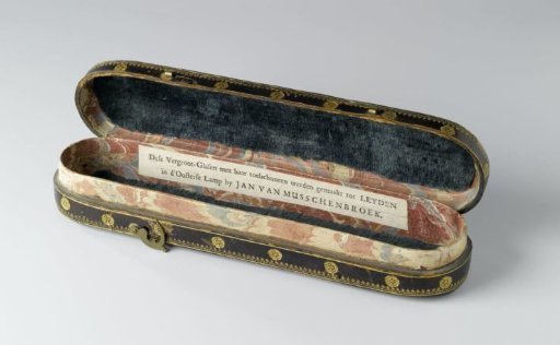 Spectacle case of thick paper covered with dark brown leather and printed with gilded floral ornaments
