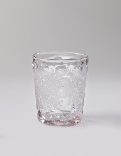 Cup with a continuous pattern of leafy vines, sunflowers, and berries