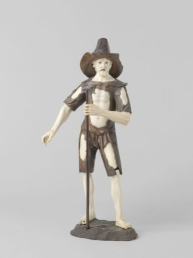 Begging figure with staff