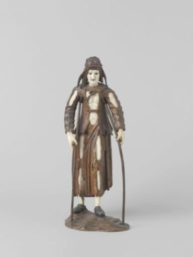 Begging figure on two crutches
