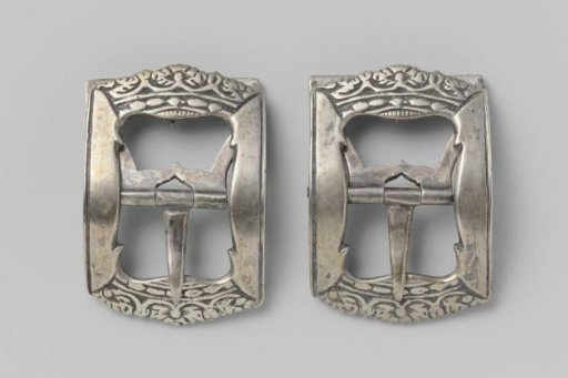 Silver brooch with sides in the shape of a crown, in flat relief