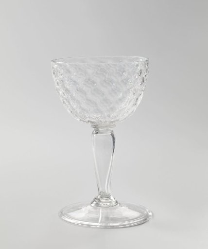 Chalice glass with a curved chalice with a honeycomb motif