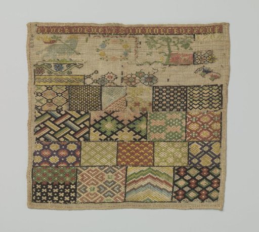 Embroidered patch of linen canvas featuring 19 different flat ornaments in silk tapestry stitch and the text RINCK CORNELIS IN NORTKOPPEN