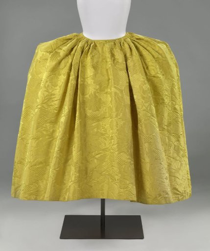 Skirt of yellow silk damask, with asymmetrical pattern with fields of trellis, rose and pomegranate